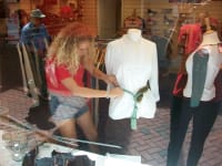 A young volunteer dresses the window in one of our charity shops