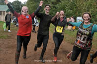 4 Commando Challenge entrants celebrate their completion of the mud run assault course