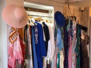 A rail of beautifu secondhand l vintage clothing and hats in Topsham Devon Air Ambulance shop