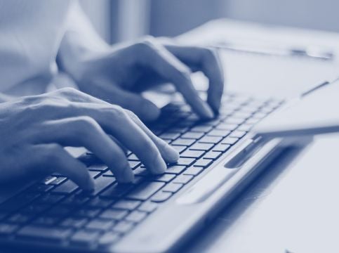 Person typing on a keyboard