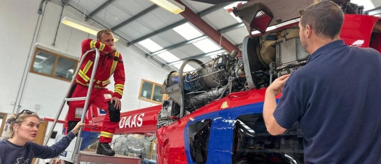 Our engineer takes a look under the bonnet with crew members watching