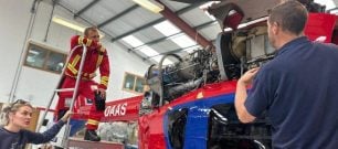 Our engineer takes a look under the bonnet with crew members watching
