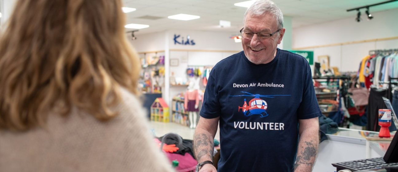 A Devon Air Ambulance volunteer assists in one of our charity shops