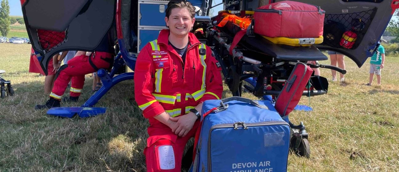A paramedic with medical kits beside our aircraft