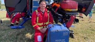 A paramedic with medical kits beside our aircraft