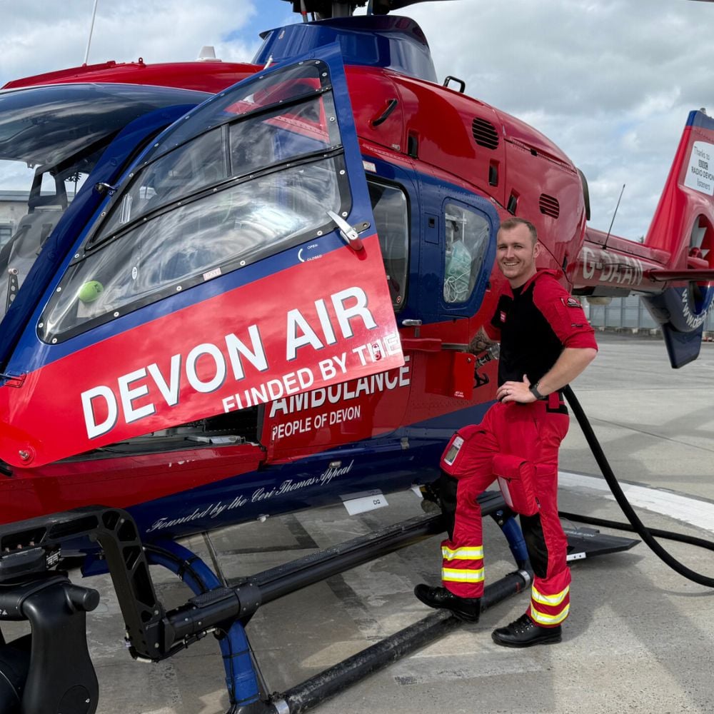 A crew member fills up the aircraft with fuel