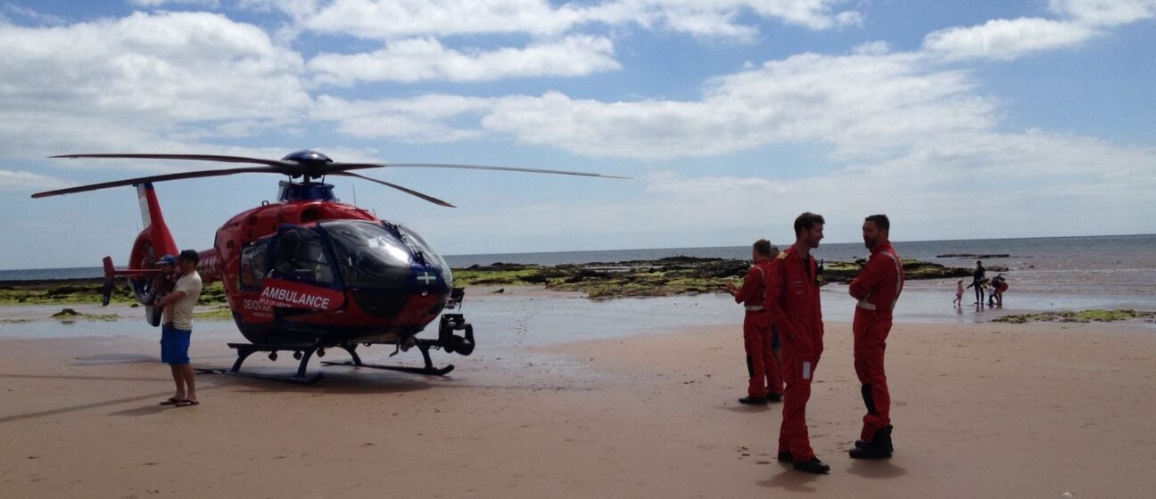 Devon Air Ambulance crew and the aircraft on Sidmouth beach